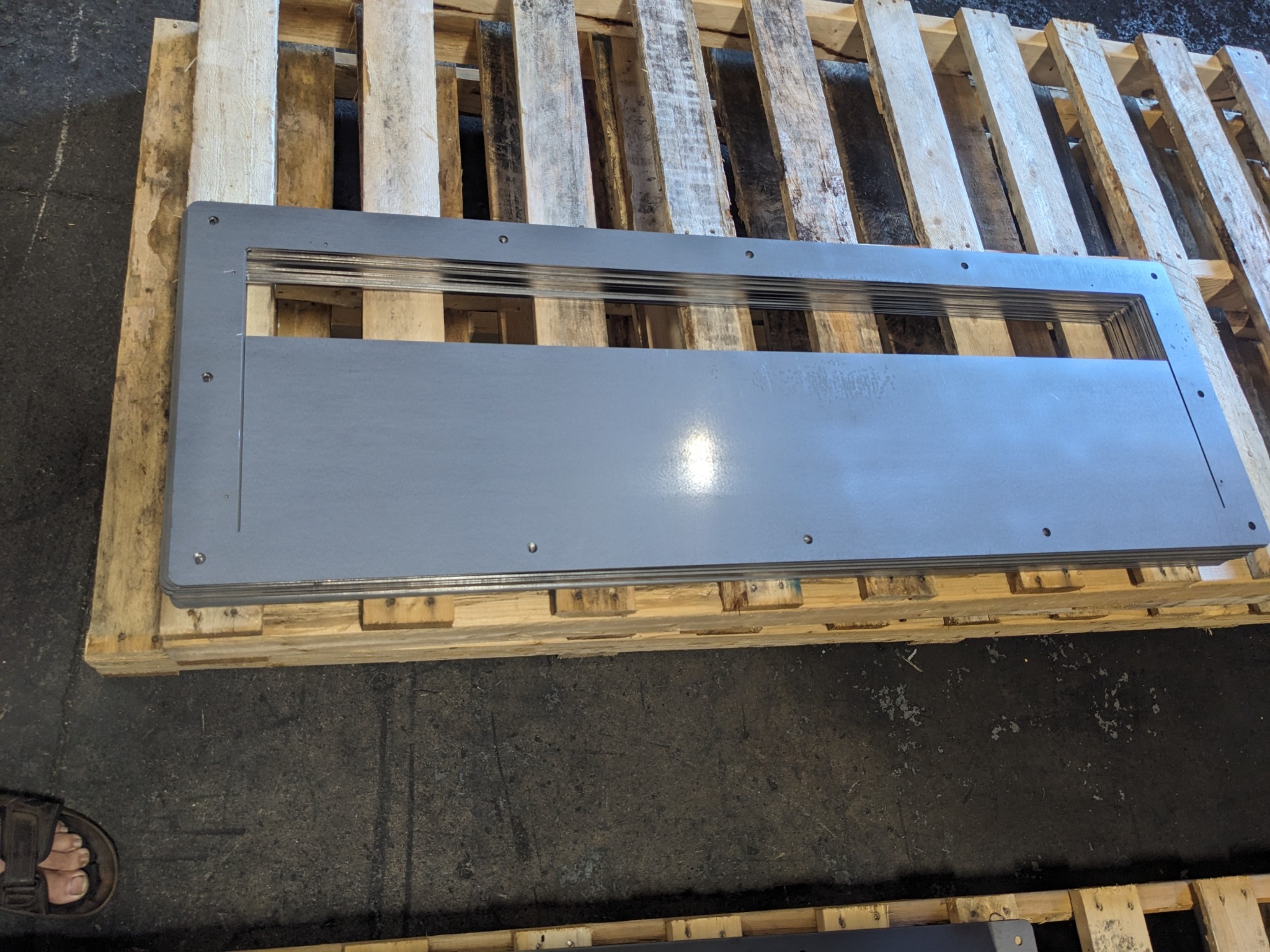 Stacked aluminum sheet parts laser cut with protective film
