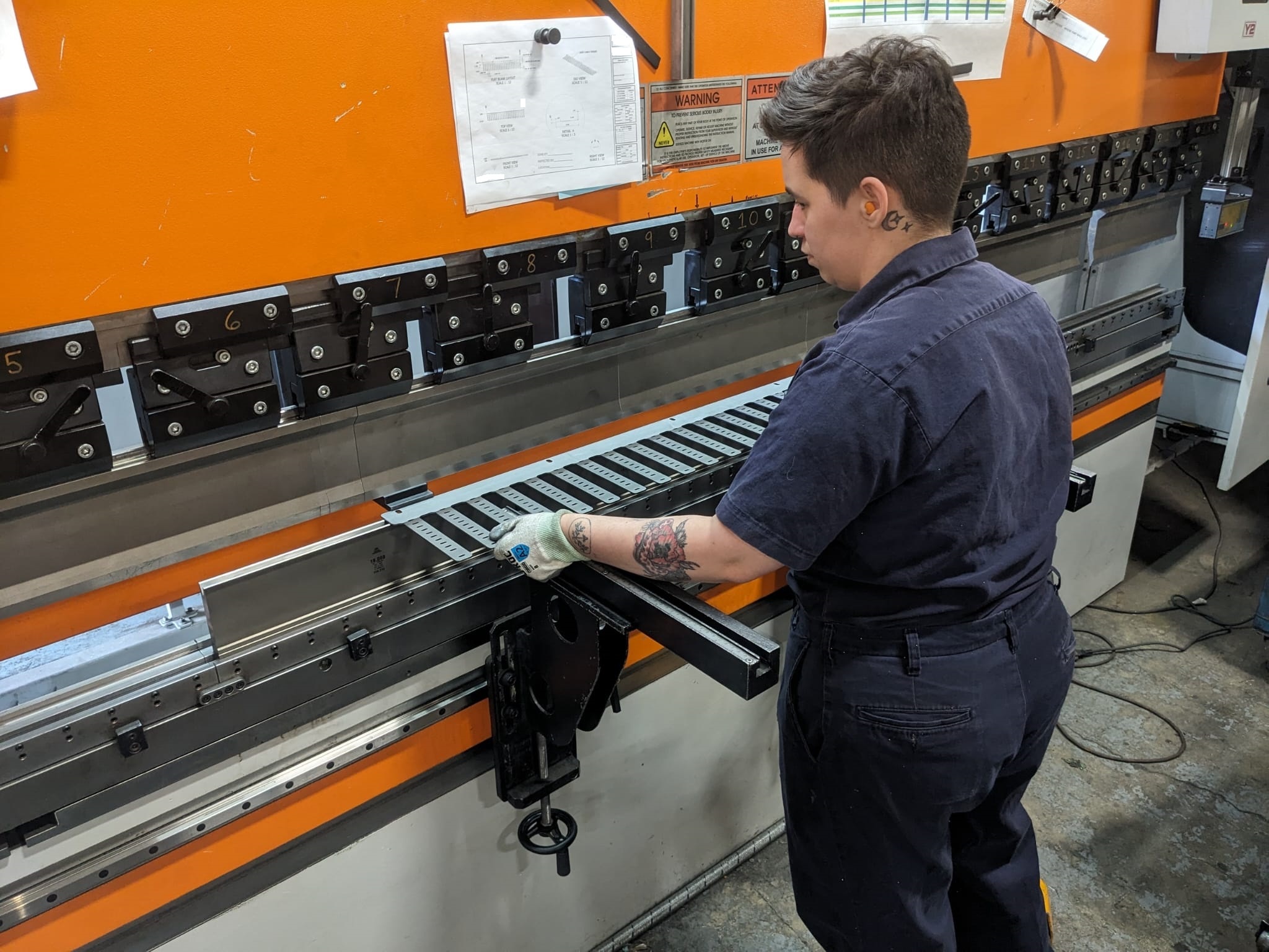 Operator forming repeat production steel parts on Seaborn Manufacturing’s CNC press brake