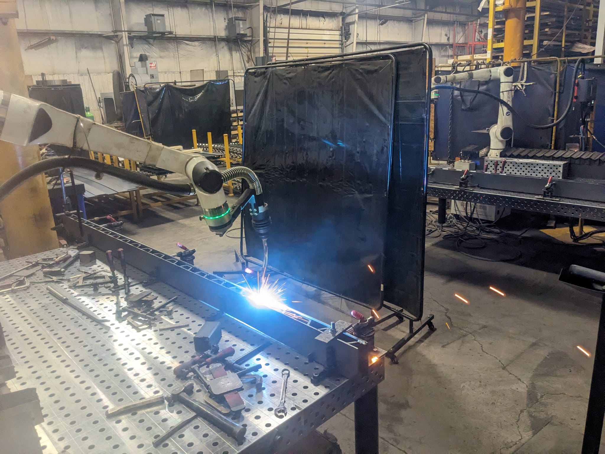 Robotic welding of a repeat production steel assembly on a 3D fixture table at Seaborn Manufacturing