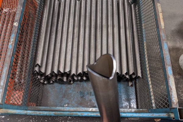 Bundle of round steel tubes with laser-cut end profiles produced by Seaborn Manufacturing